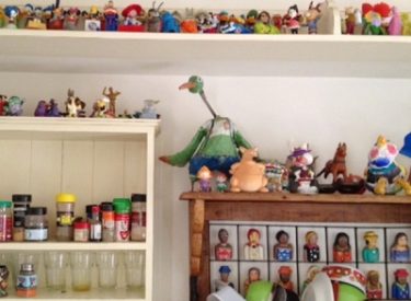 a collection of plastic toys, displayed in the kitchen